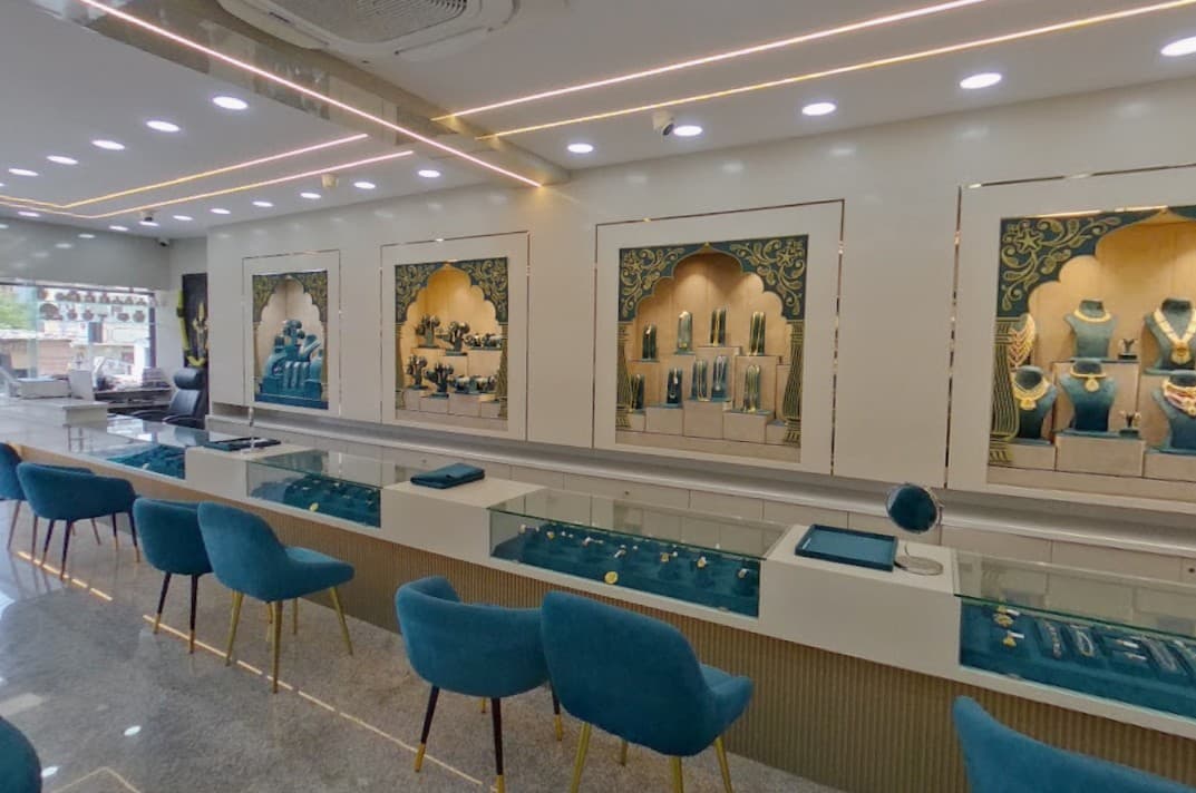 Inside Nakshatra Jewellers showroom with teal velvet counters and arched display niches